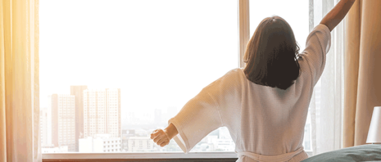 woman waking up in hotel room